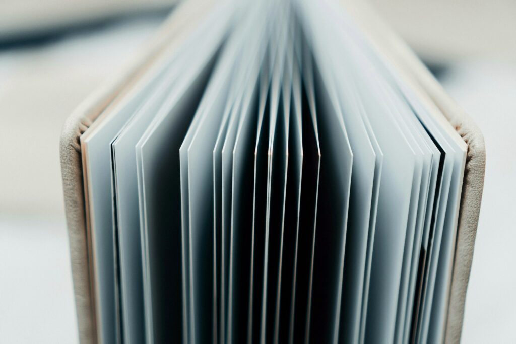 The thick pages of a lay-flat photo album fanned open