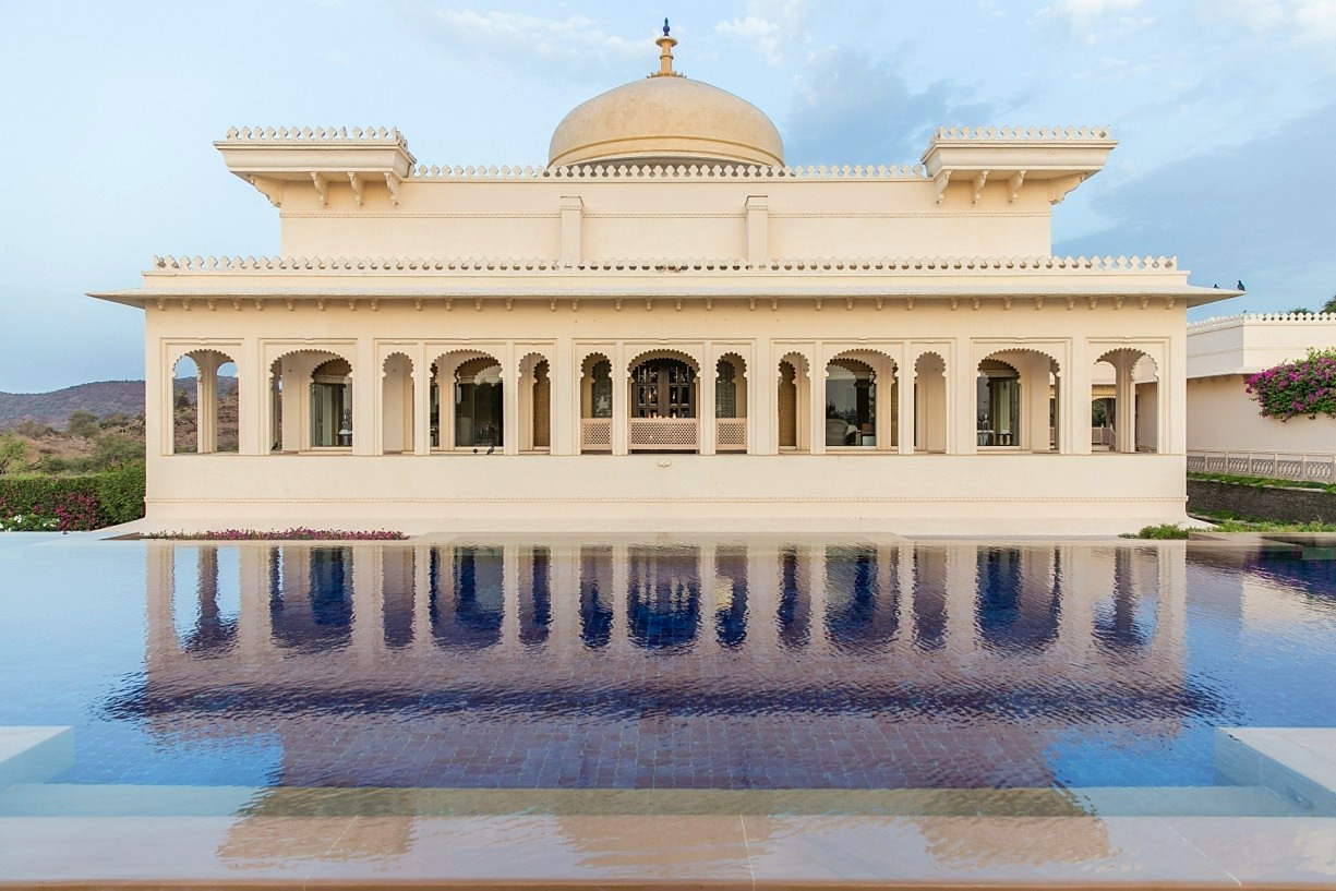 A domed white palace mirrored in a still reflecting pool